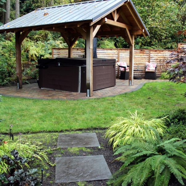 View of the hot tub (for soak) and lounge (for sip) from the path leading from front entry.