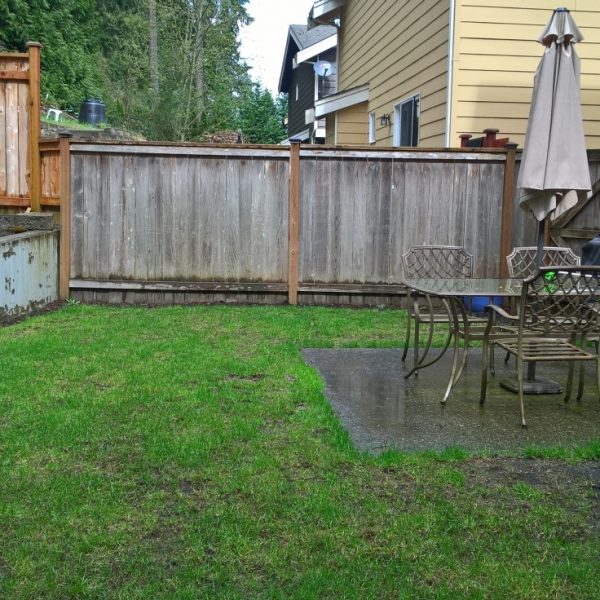 Postage stamp patio, narrow steps, unsightly concrete wall, soggy lawn